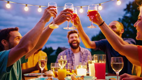 friends enjoying an outdoor evening dinner party and toast