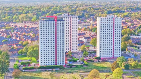 Tall-white-apartment-buildings-with-modern-red-stripe-along-elevator-at-sunrise-in-Manchester