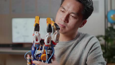 man examining a robotic hand