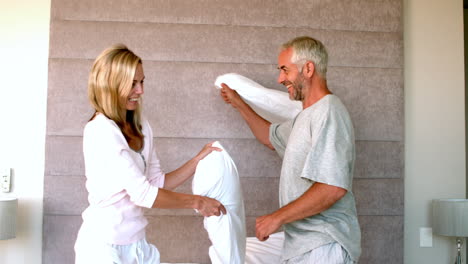 Mature-couple-having-a-pillow-fight