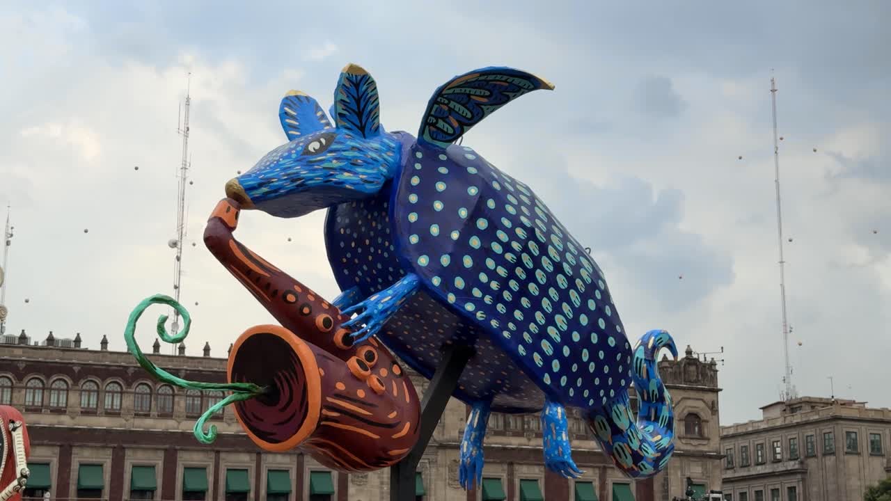 Colorful alebrije sculpture of winged armadillo playing saxophone on display outdoors