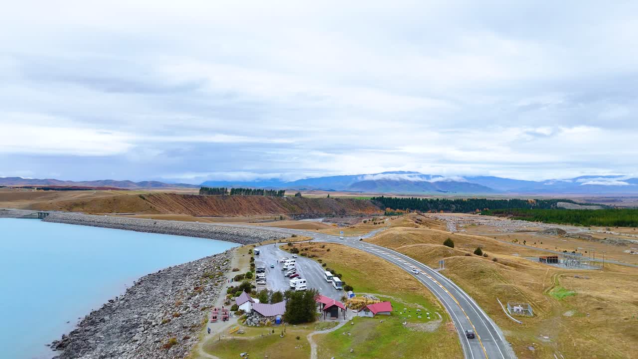 Aerial View of a Scenic Roadside Lake and Mountain Scenery
