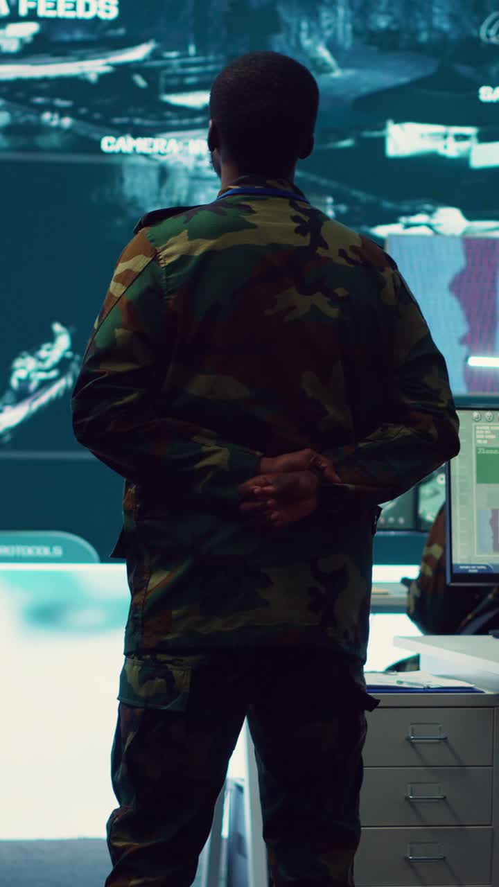 Soldier in Camouflage Uniform Observing Data in Control Room