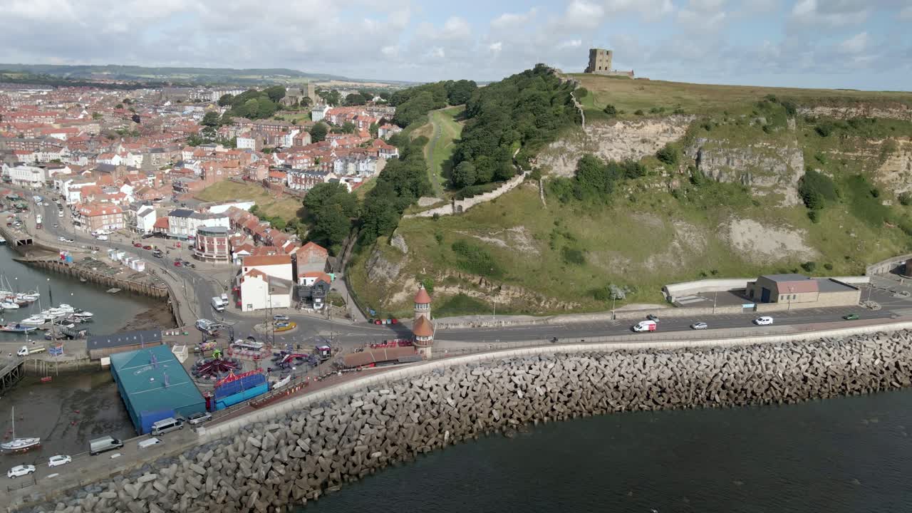 Aerial bird's eye view of Scarborough south bay town, beach, harbor and castle