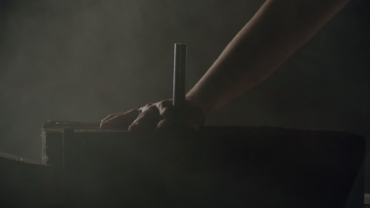 Hammer hitting a big nail in a dramatic misty ambience