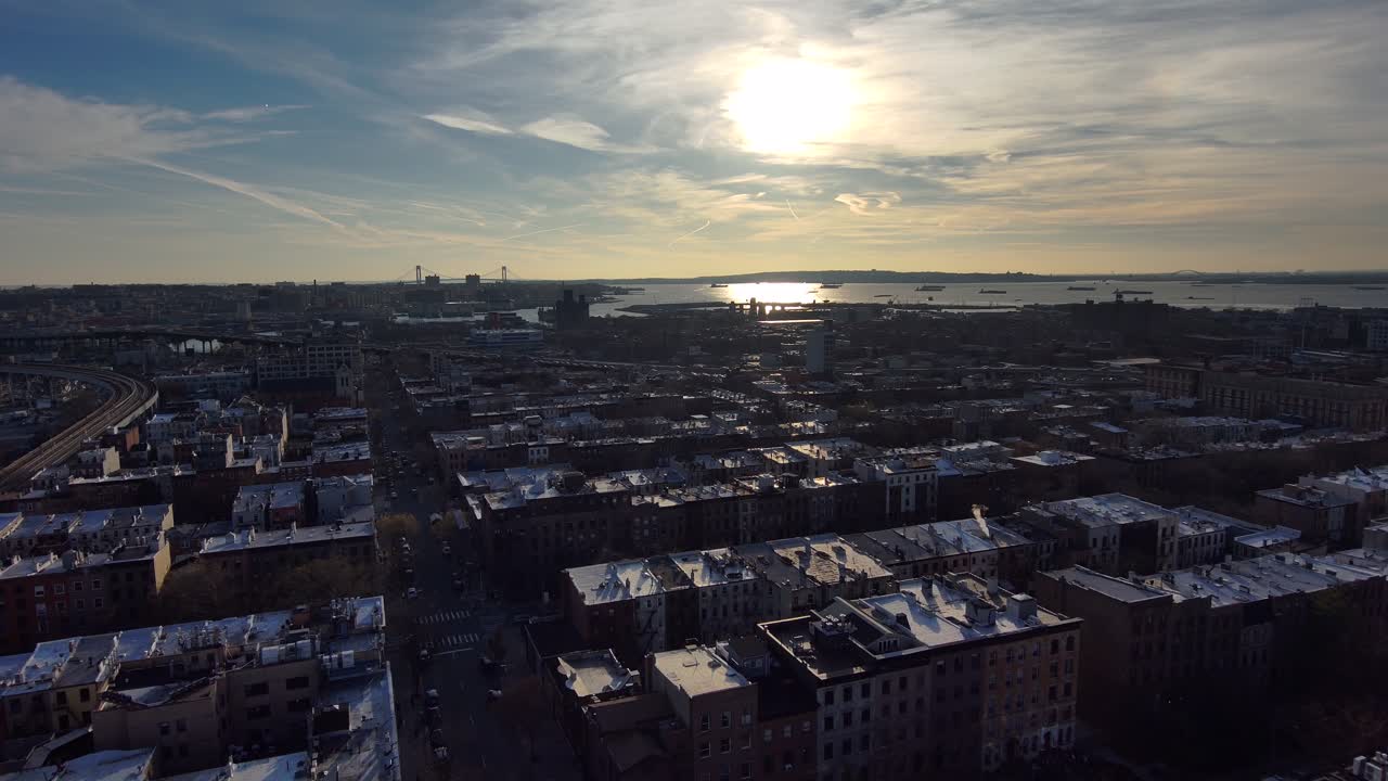 Aerial Establishing Shot Of Brooklyn Apartments And Residential District With Manhattan New York City Skyline Distant Sunset