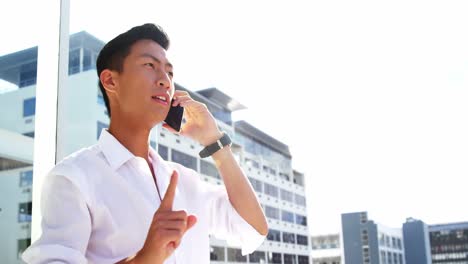 a man calling on his smartphone and pointing something