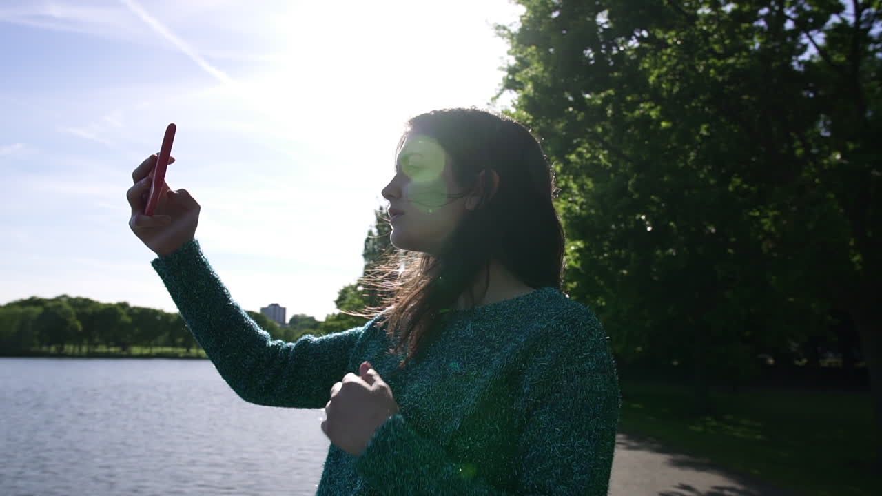 Pretty Italian Woman Tourist Taking Photograph of a Park in Wimbledon London