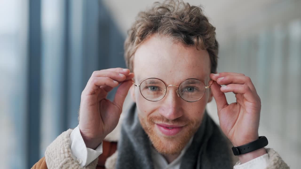 close-up portrait Handsome adult man puts on glasses