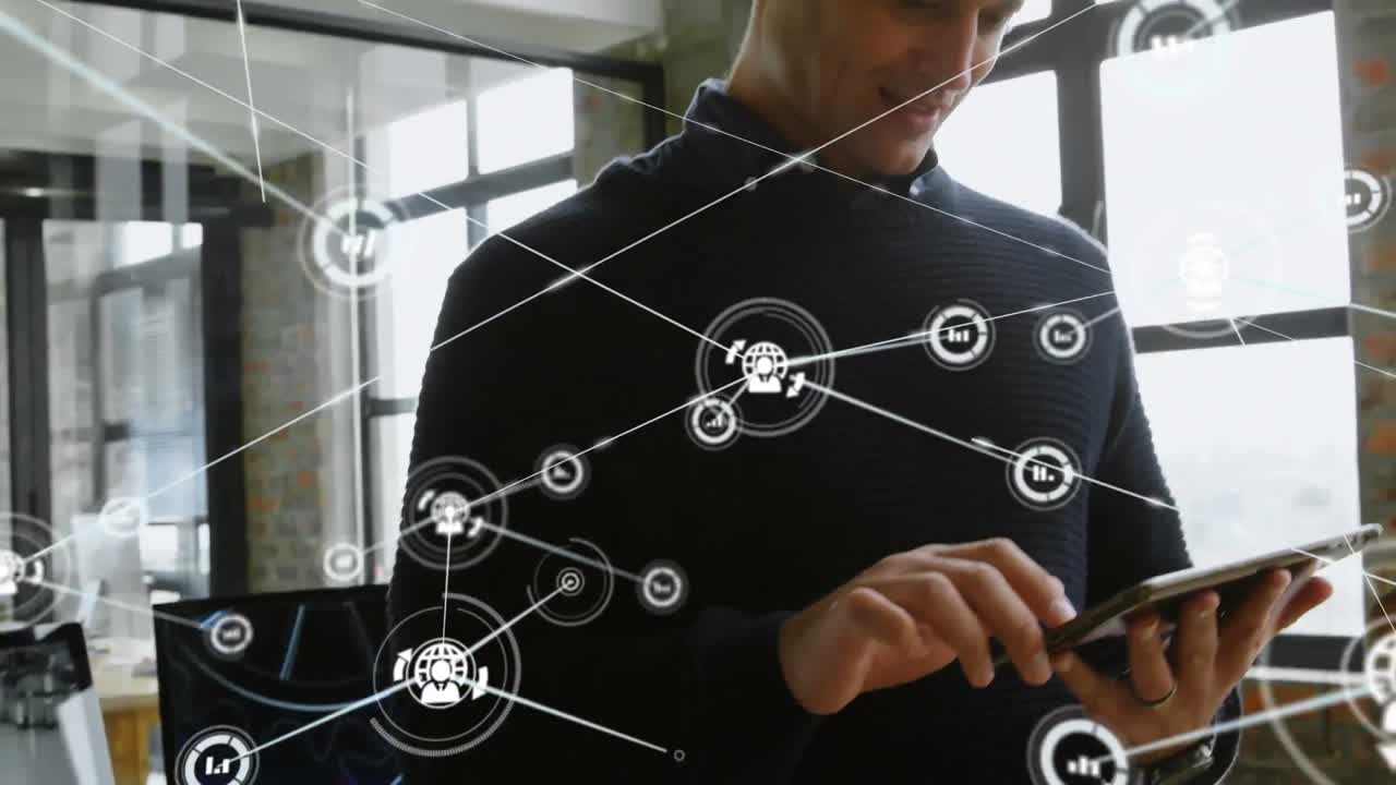 Network of digital icons against caucasian businessman using digital tablet at office