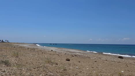 crystal-clear 4k view of mandria beach in cyprus with pebbles, gentle sea waves, and blue sky. a peaceful coastal moment—ideal for travel, nature, and relaxation footage in ultra hd.