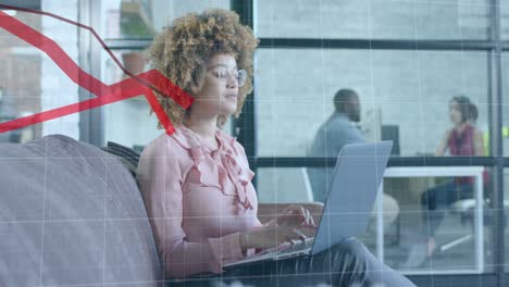 Red-graph-processing-over-biracial-casual-businesswoman-using-laptop-in-office-lounge