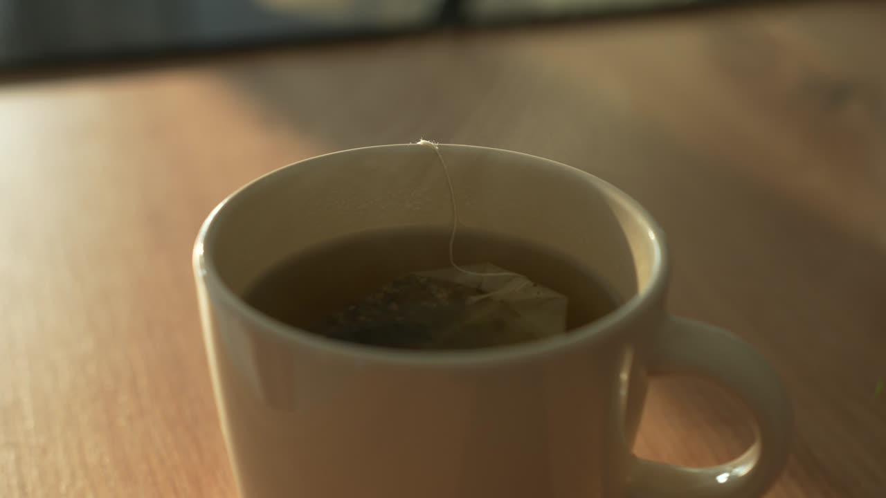 primer plano de la elaboración del té en una taza de crema y montar en vapor