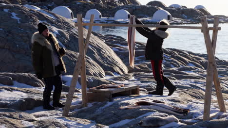 inuit people fishing and preparing food in the arctic