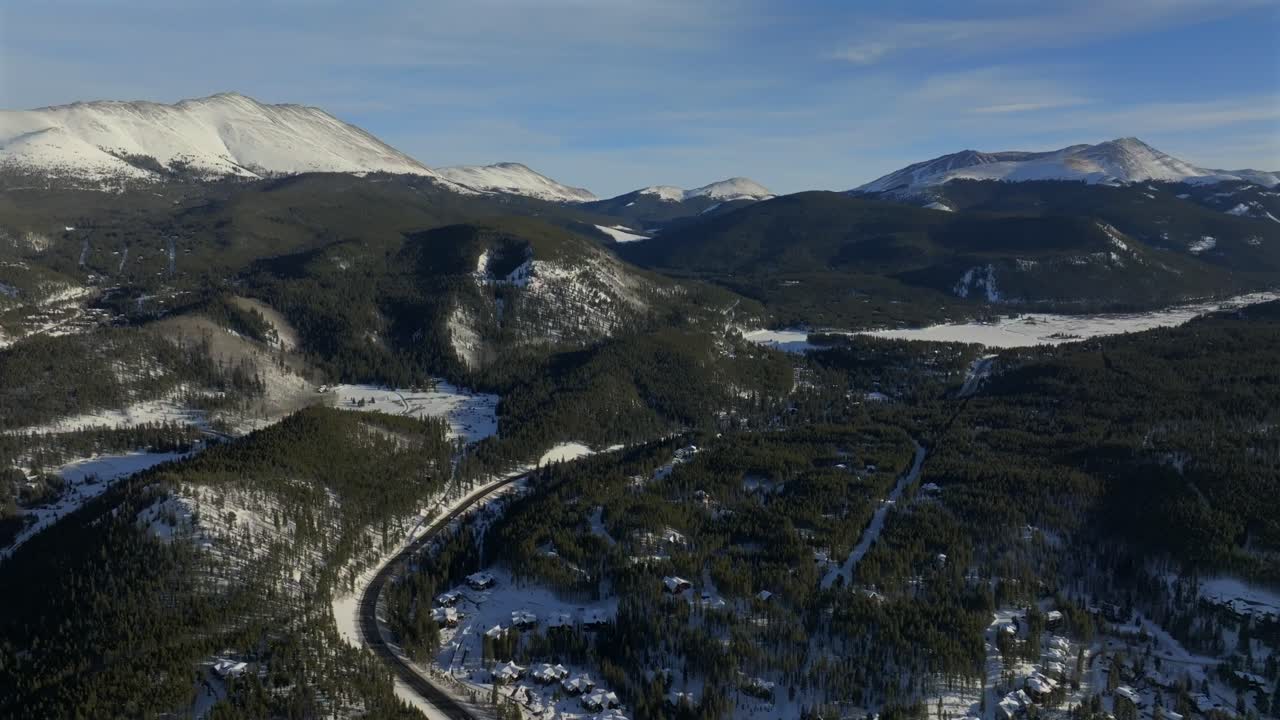 Blue River Valley Breckenridge mountain town Colorado aerial drone Winter December January skiing trails run Peak 9 10 Ten Mile Range Epic Vail Pass cirrus clouds chairlifts forward pan up motion