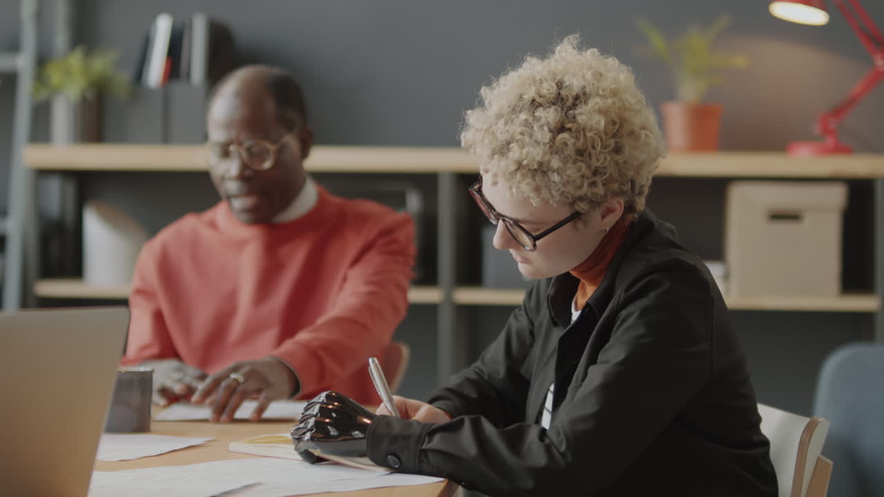 Business Meeting with Diverse Colleagues, Including a Woman with a Prosthetic Arm