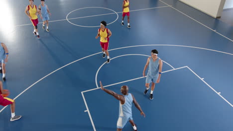 competing on basketball court, players focusing on teamwork and strategy indoors