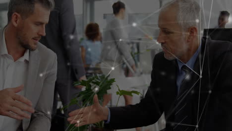 businessmen shaking hands with network connections animation over office background