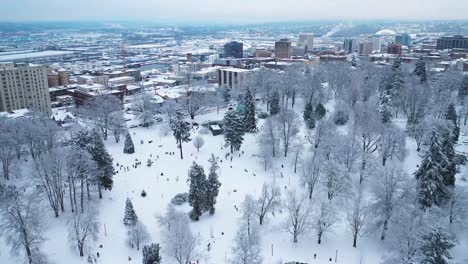 wright park and cityscape covered by snow in tacoma, washington, usa - aerial drone shot