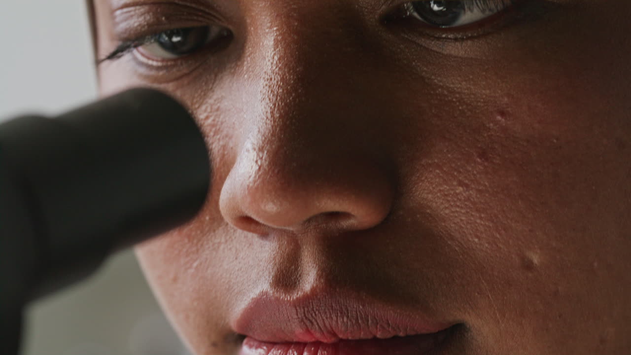 Close Up of Female Researcher Looking through Microscope in Lab