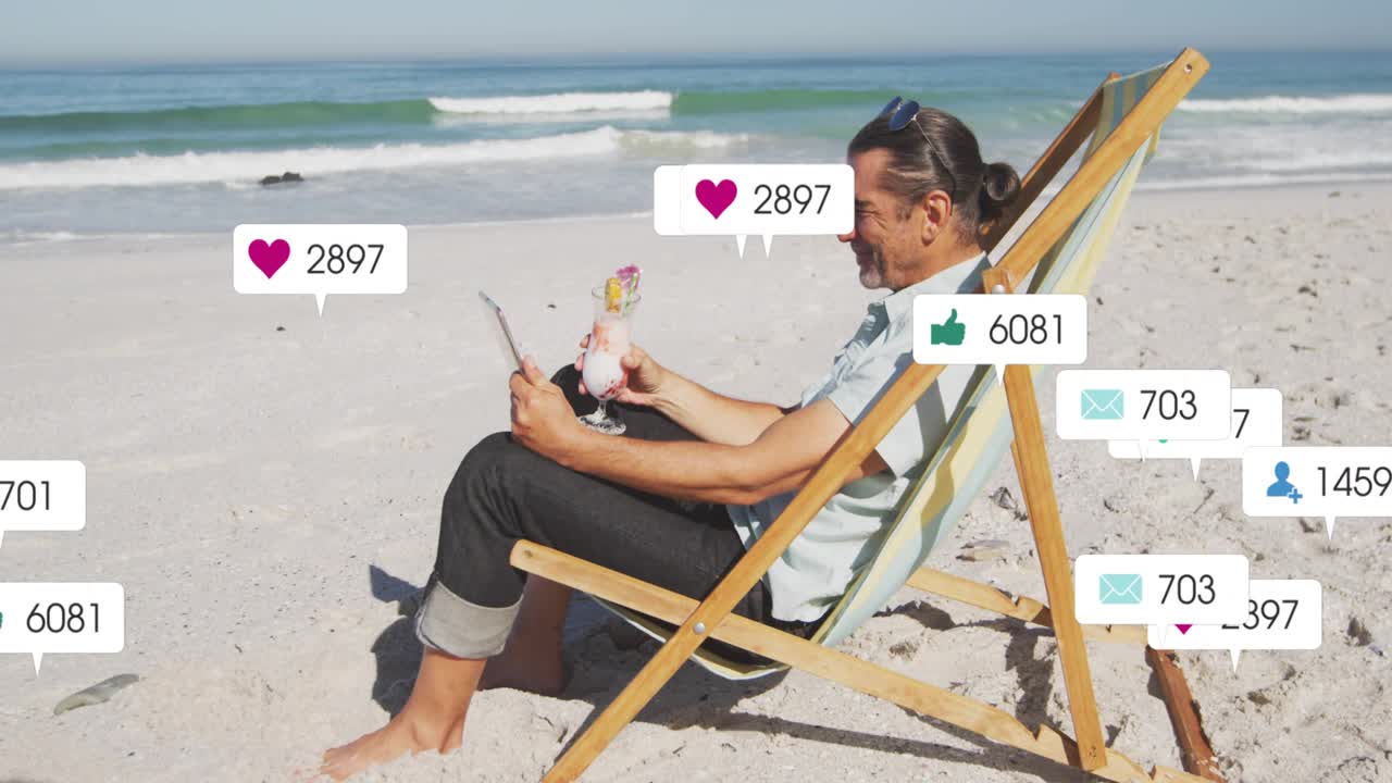 Man sipping drink, tapping tablet at beach, generating social media alerts clustering around him