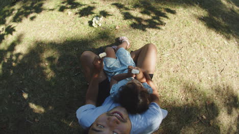 Above-view-of-happy-man-with-little-daughter-eating-chocolate-ice-creams