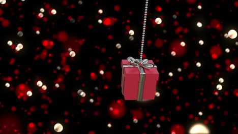 Animación-De-Adorno-Navideño-De-Regalo-Rojo-Sobre-Fondo-De-Manchas-De-Luces.