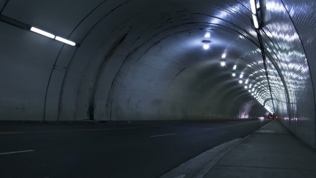 Time lapse shot of cars passing through a tunnel