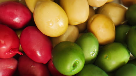 pickled round green olives from greece as background, top view. high quality 4k footage