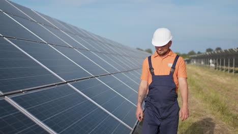 solar panel technician inspecting solar panels