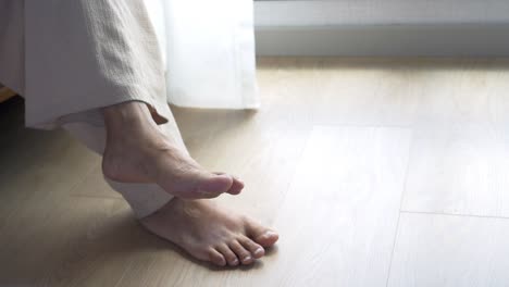 a woman's bare feet resting on the floor