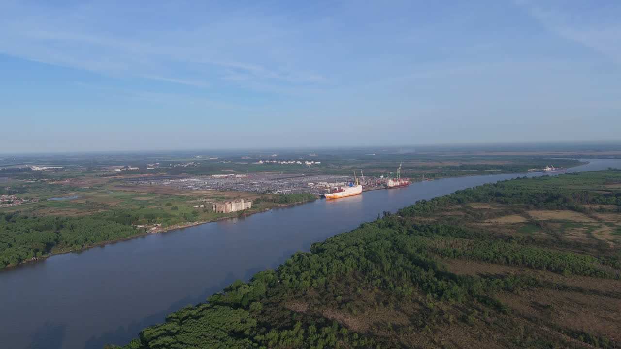 Aerial view of Zarate cargo port on banks of Paraná River in Buenos Aires, Argentina. 4k.