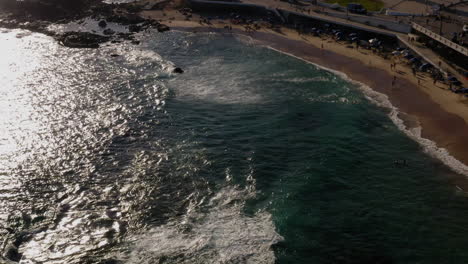 Aerial-view-of-Farol-da-Barra,-the-sea-and-the-neighborhood-around,-Salvador,-Bahia,-Brazil