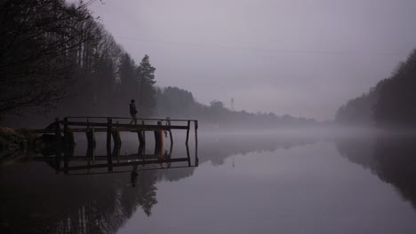 girl walking on pier in misty weather