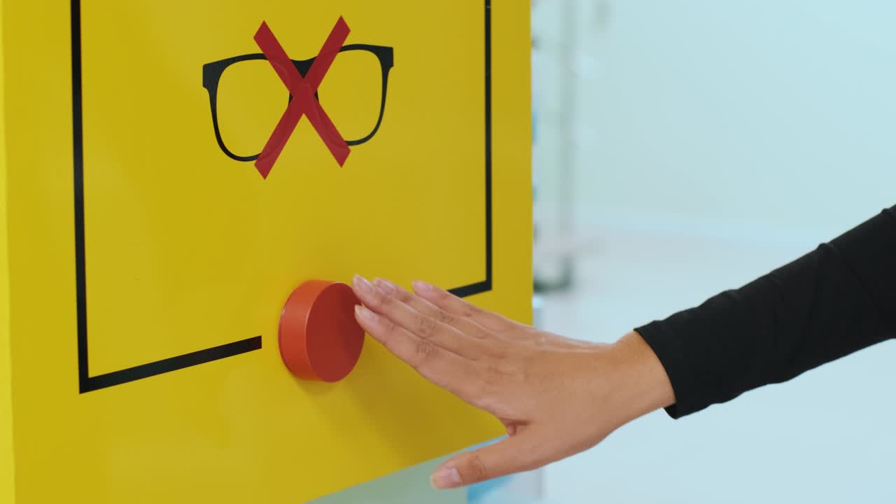 Hand pushing a red button no more glasses