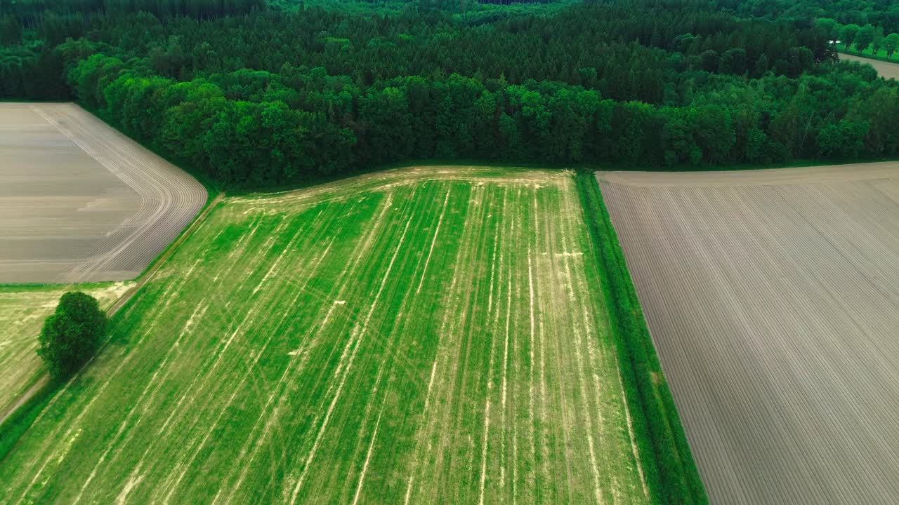 aerial shot of plowed farmland and green fields, 4k