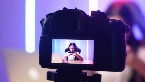display camera of asian kid girl playing video game with mobile phone then lose the game while live stream