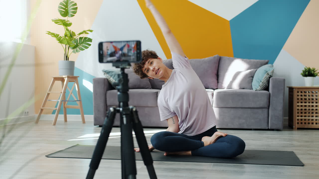 Woman Doing Yoga and Video Tutorial at Home