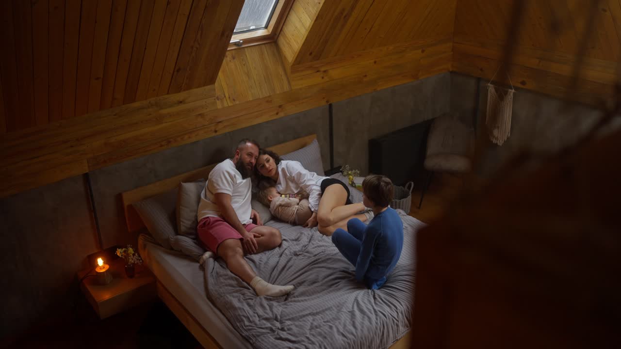 Famiglia che si rilassa insieme in una camera da letto accogliente
