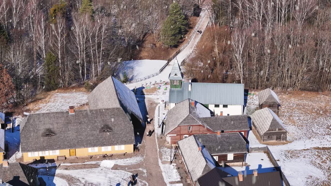 Downtown of historical township in Lithuania during snowfall, aerial view