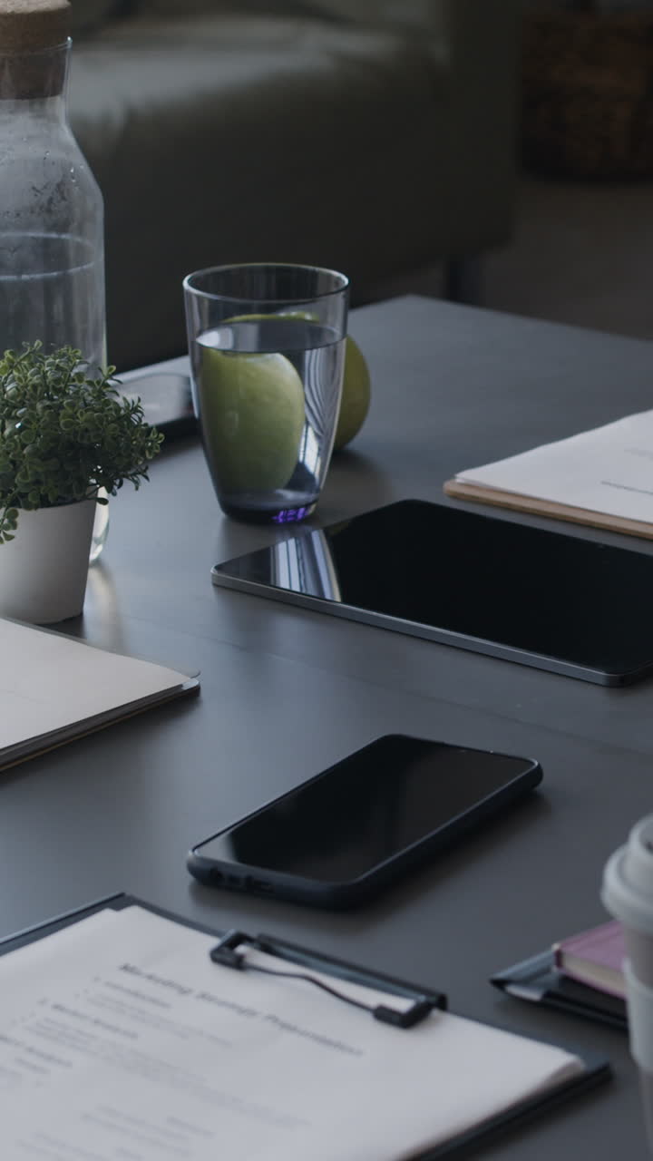 Modern Workspace with Documents, Devices, and Drinks