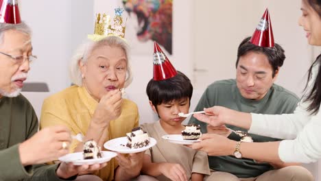 a family enjoys a birthday celebration, sharing cake and laughter in a warmly lit room