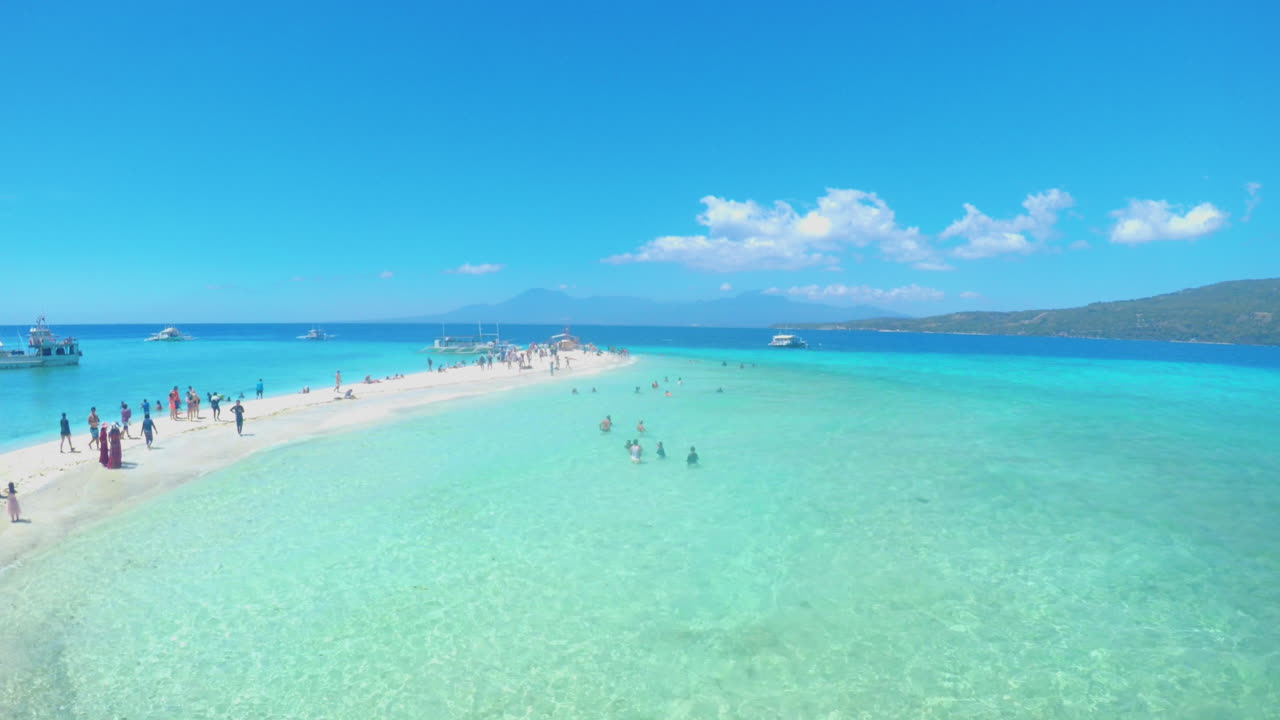 Relaxing View of Beach and Sandbar with Tourist in the Background of Sumilon Island, Philippines