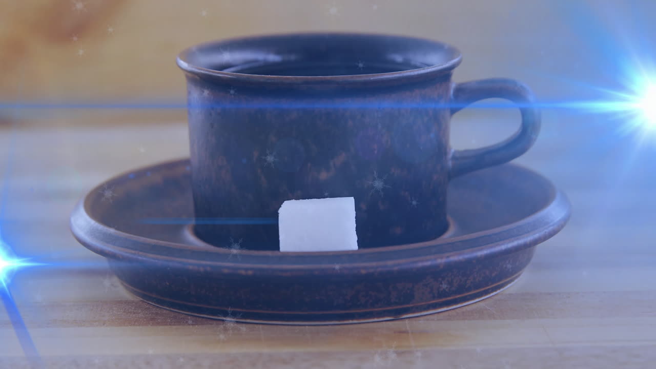 Rustic ceramic cup being animated in 3D on wooden table, with sugar cube and lens?flare effects