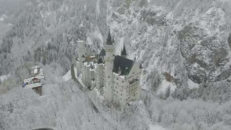 aerial view of neuschwanstein flying to top of the castle in winter