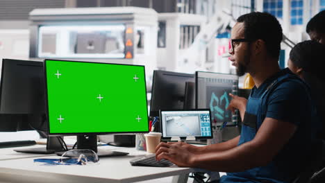 african american male engineer does troubleshooting on copy space display