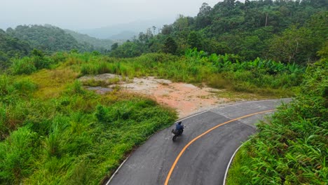 motorcycle rider on a winding mountain road