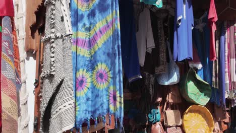 colorful traditional garments and textiles displayed in tangier medina, morocco