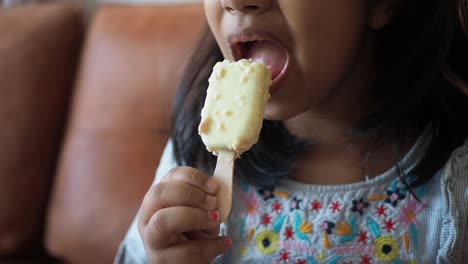 little girl enjoying a white chocolate popsicle