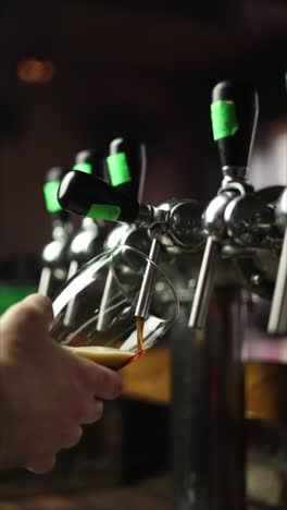 pouring dark beer at a bar